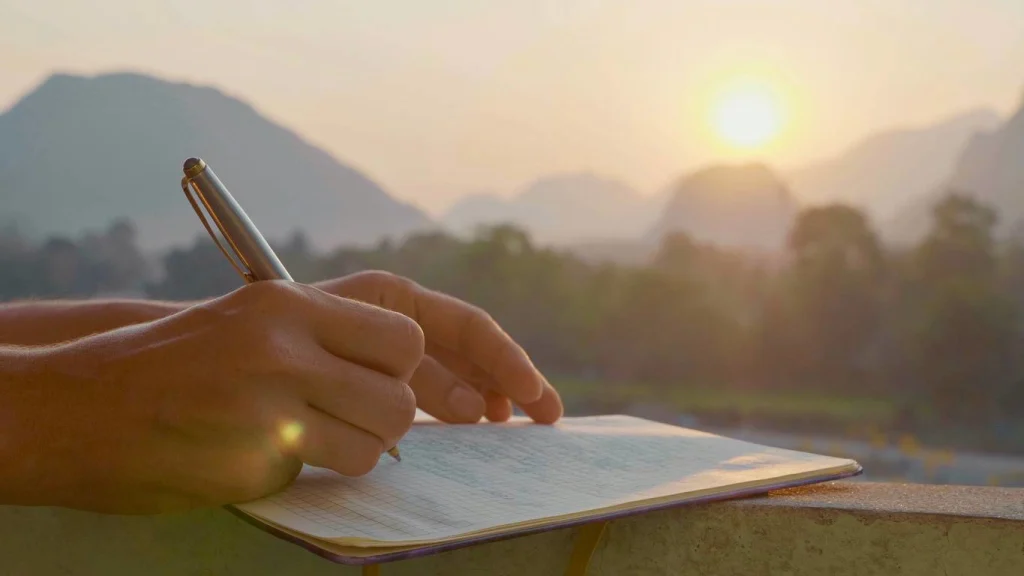 Woman writing in gratitude journal